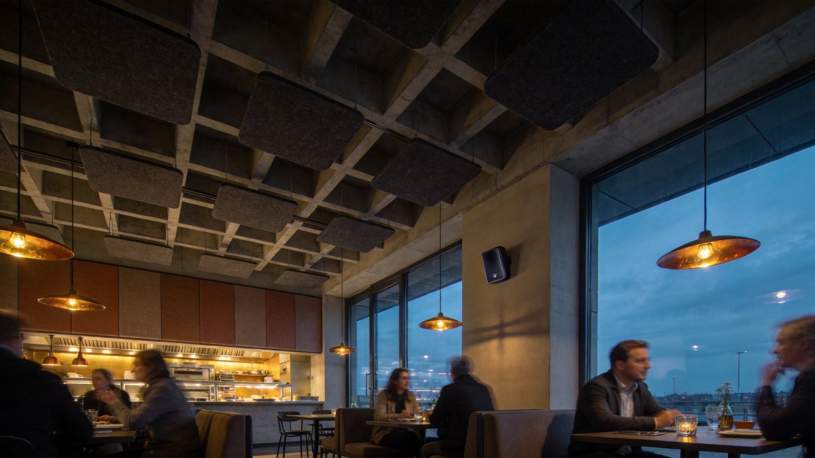 Restaurant interior with dark acoustic ceiling islands and fabric-covered wall panels that blend into the design